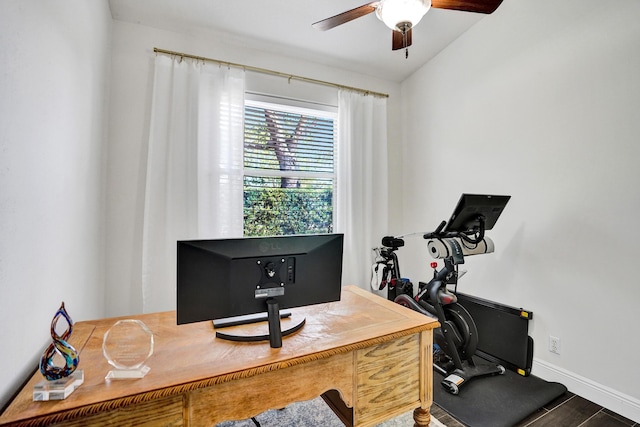 home office featuring a ceiling fan, wood finished floors, and baseboards