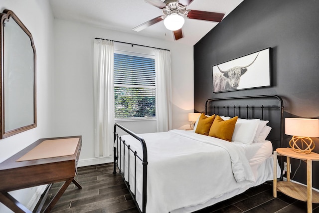 bedroom featuring wood tiled floors, baseboards, and a ceiling fan