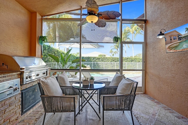sunroom / solarium with a ceiling fan, exterior kitchen, outdoor lounge area, and vaulted ceiling