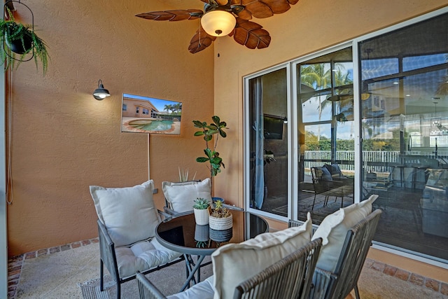 sunroom / solarium with a ceiling fan