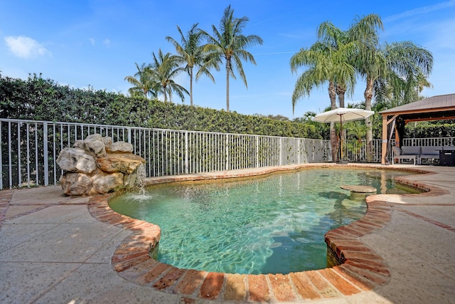 view of pool with a gazebo, fence, and a patio area