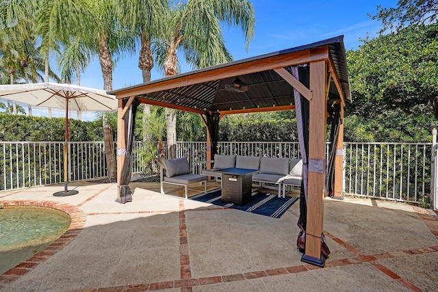 view of patio with a gazebo, ceiling fan, an outdoor living space, and a fenced backyard