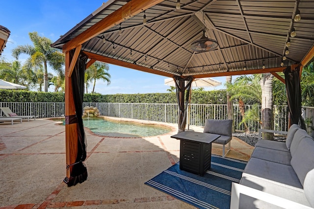 view of patio / terrace featuring a gazebo, a fenced backyard, and an outdoor hangout area