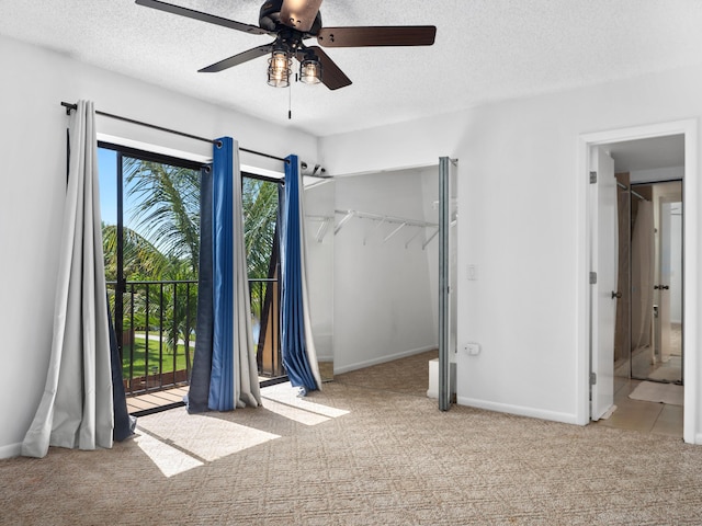 unfurnished bedroom with carpet flooring, a textured ceiling, access to exterior, ceiling fan, and baseboards