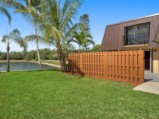 view of yard with a water view and a balcony