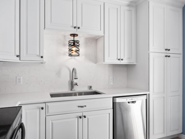 kitchen featuring stainless steel dishwasher, a sink, tasteful backsplash, and white cabinetry