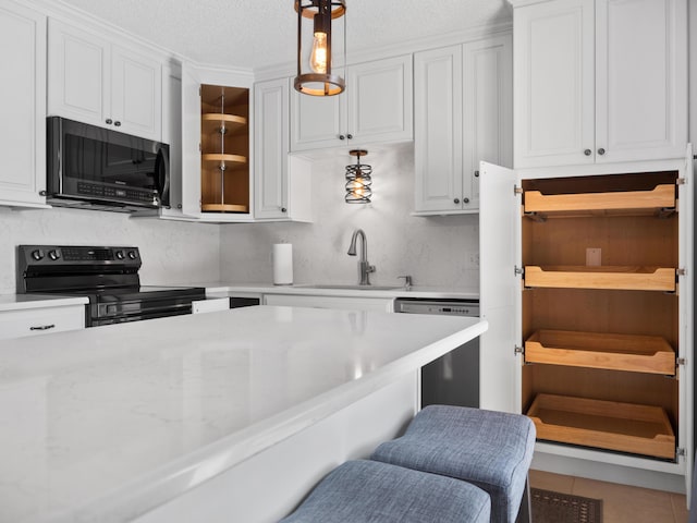 kitchen with stainless steel range with electric cooktop, a sink, dishwasher, a kitchen breakfast bar, and white cabinets