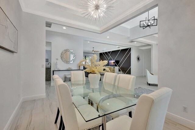 dining area with a chandelier, baseboards, recessed lighting, a tray ceiling, and crown molding