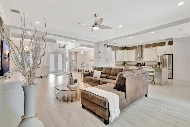 living room featuring ornamental molding, a ceiling fan, and recessed lighting