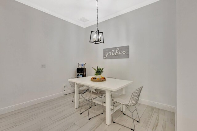dining room with baseboards, ornamental molding, a chandelier, and light wood-type flooring
