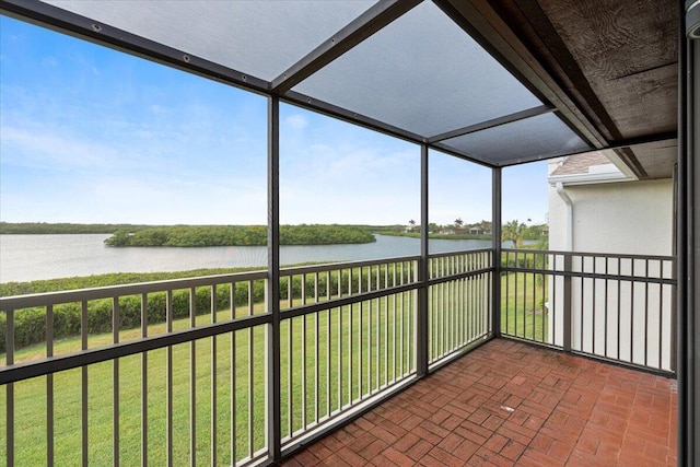 unfurnished sunroom with a water view