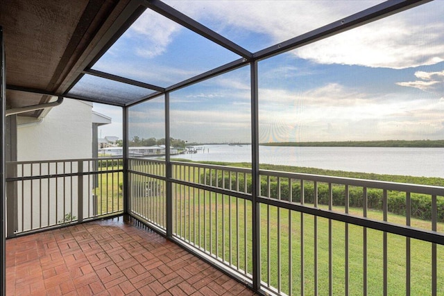 unfurnished sunroom featuring a water view