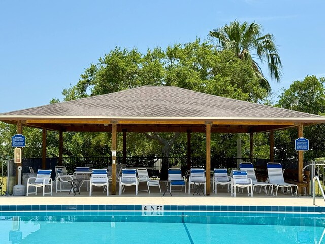 community pool featuring a gazebo and fence