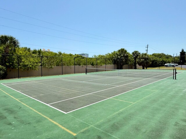 view of tennis court with fence and community basketball court