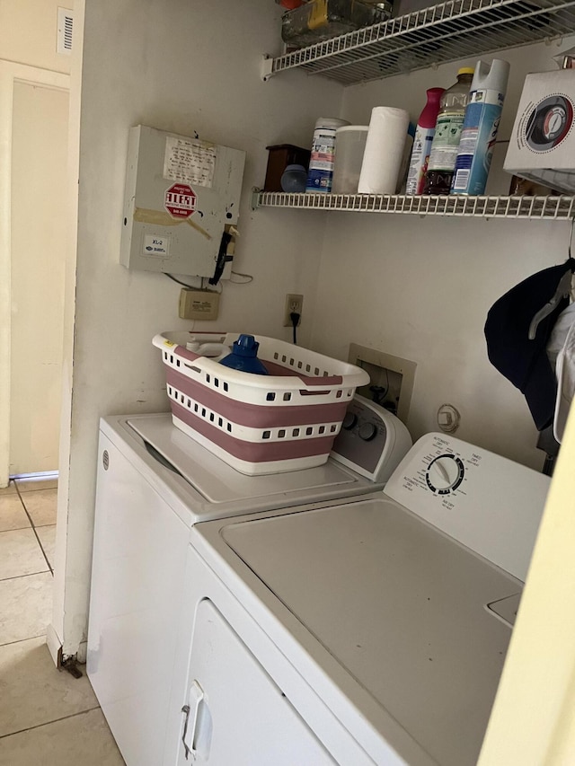 laundry area featuring independent washer and dryer and light tile patterned flooring