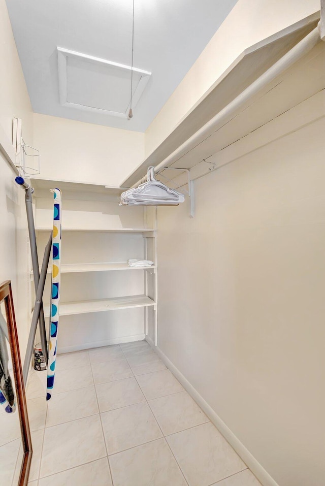 spacious closet featuring light tile patterned floors