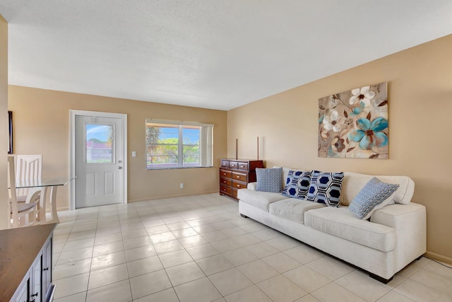 living room with baseboards and light tile patterned floors