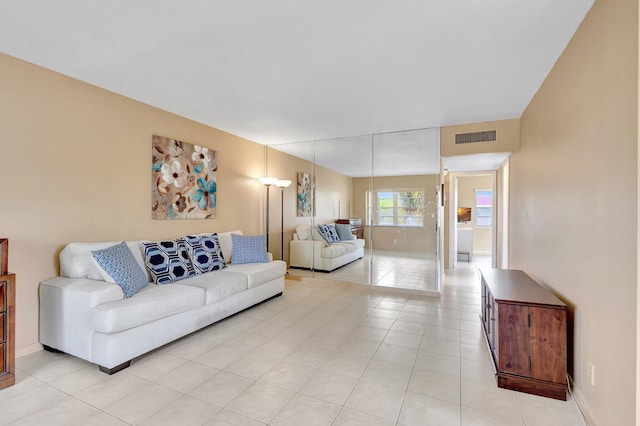 living area with light tile patterned floors and baseboards