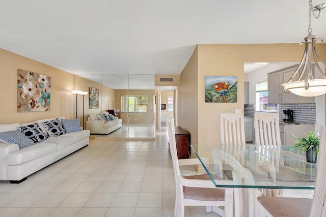 dining room with plenty of natural light and light tile patterned floors