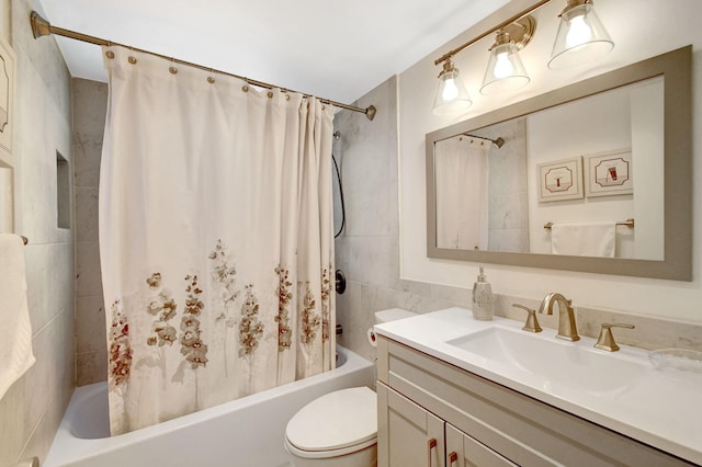 full bathroom featuring shower / bath combo, vanity, toilet, and tile walls