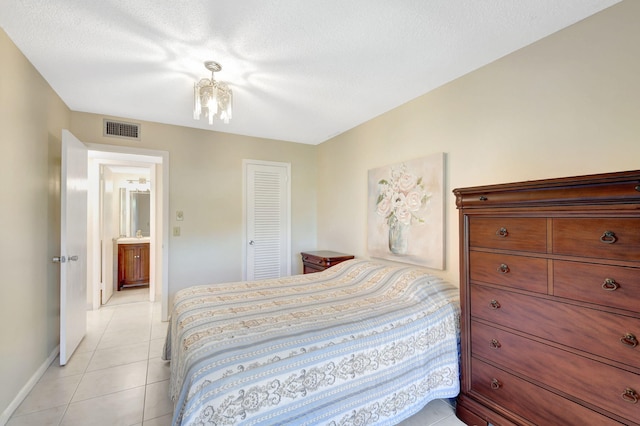 bedroom featuring light tile patterned flooring, baseboards, and a closet