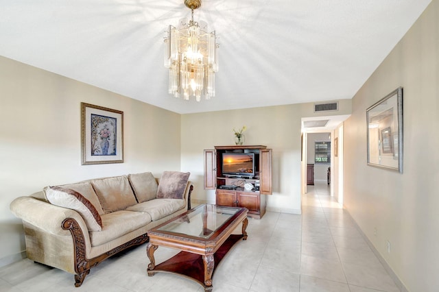 living area with a chandelier, light tile patterned flooring, and baseboards