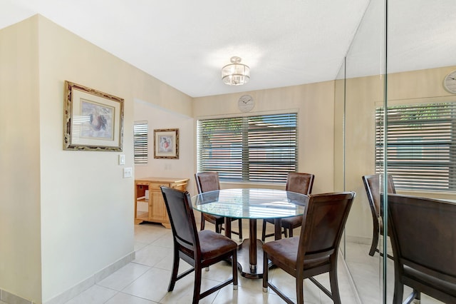 dining area featuring baseboards and light tile patterned flooring