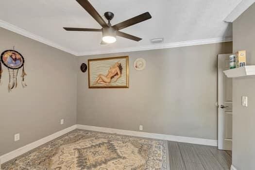 701 SW 1st Ave S, Boynton Beach, FL 33426 - spare room with ceiling fan, crown molding, baseboards, and wood finished floors