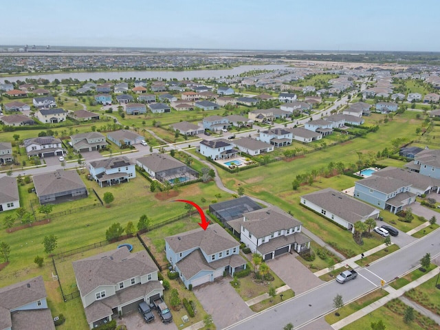 view of property location with a large body of water and nearby suburban area
