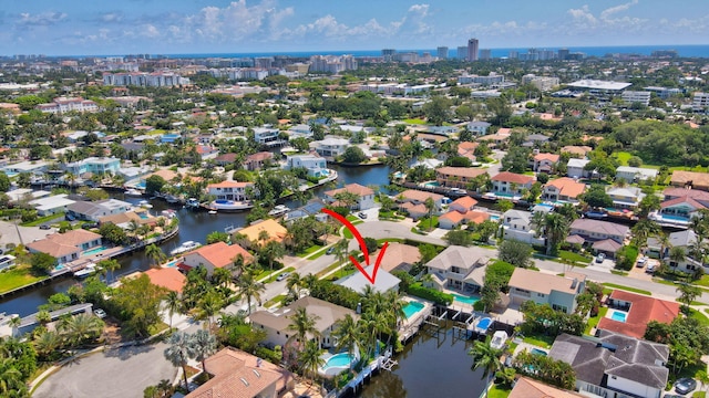 view of property location featuring nearby urban area, a large body of water, and nearby suburban area