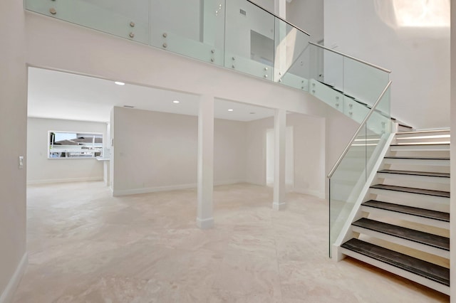 staircase featuring a towering ceiling