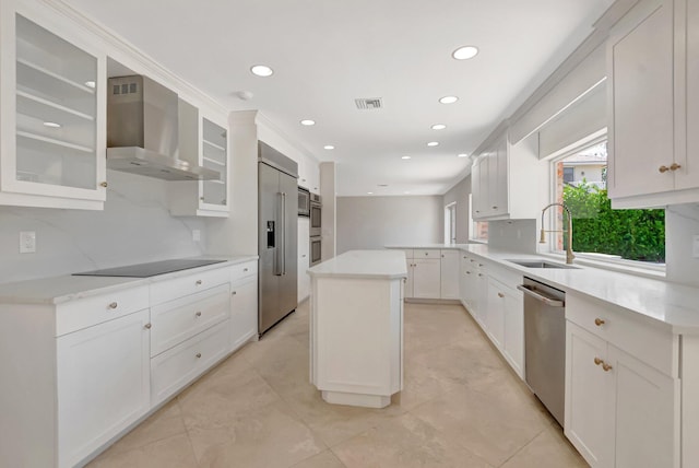 kitchen featuring wall chimney range hood, a sink, appliances with stainless steel finishes, recessed lighting, and tasteful backsplash