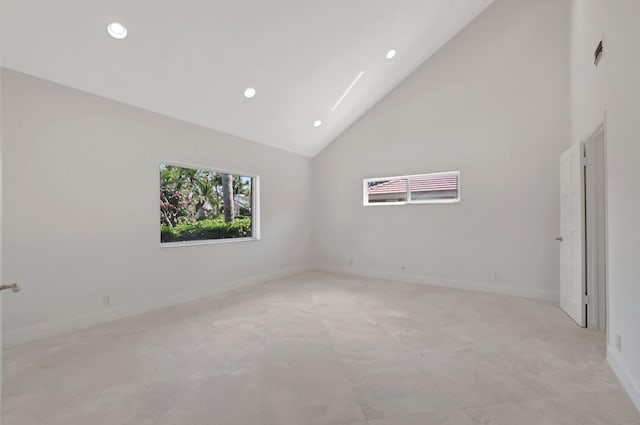 empty room featuring high vaulted ceiling, recessed lighting, and baseboards