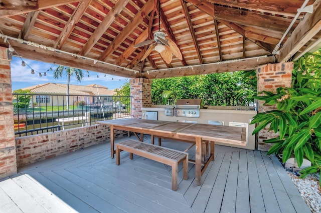 wooden terrace with a gazebo, a ceiling fan, a grill, area for grilling, and outdoor dining area