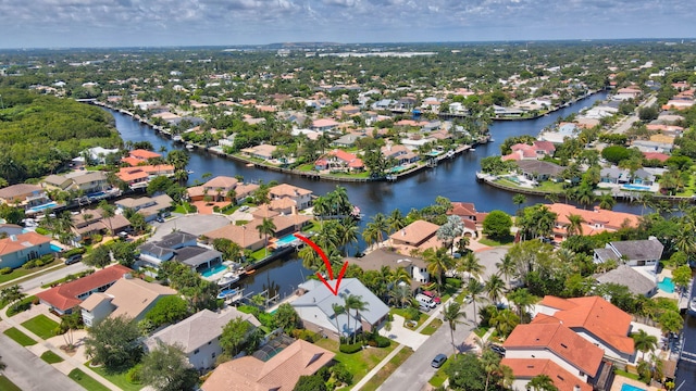 aerial overview of property's location with nearby suburban area and a nearby body of water