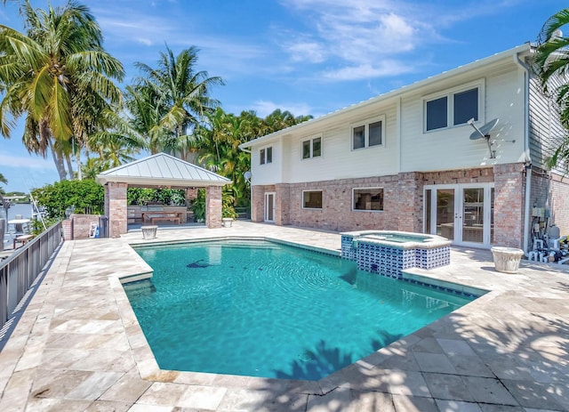 view of swimming pool featuring a gazebo, french doors, a patio area, and a pool with connected hot tub