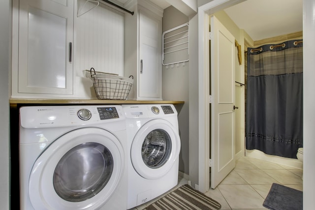 laundry area with separate washer and dryer and light tile patterned floors