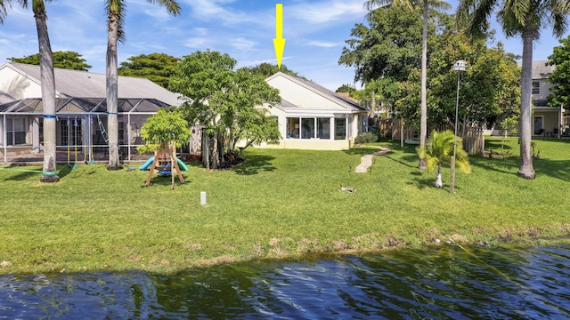 rear view of property featuring a yard and a water view