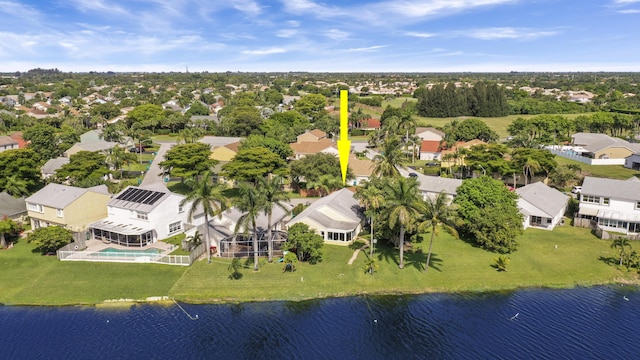 aerial view of residential area featuring a pool area and a nearby body of water