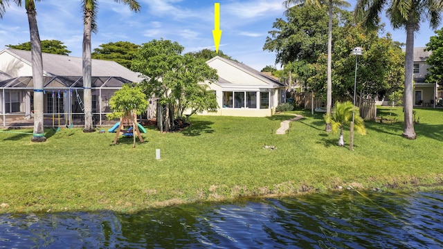 back of house featuring a water view and a yard