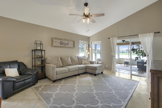 living area featuring a ceiling fan, light tile patterned floors, and high vaulted ceiling