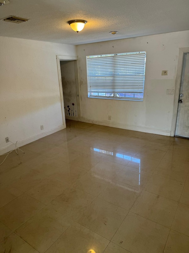 4420 NW 34th St, Lauderdale Lakes, FL 33319 - spare room featuring baseboards and a textured ceiling