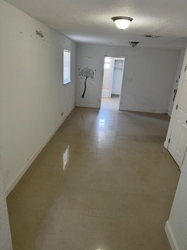 4420 NW 34th St, Lauderdale Lakes, FL 33319 - spare room with a textured ceiling and baseboards