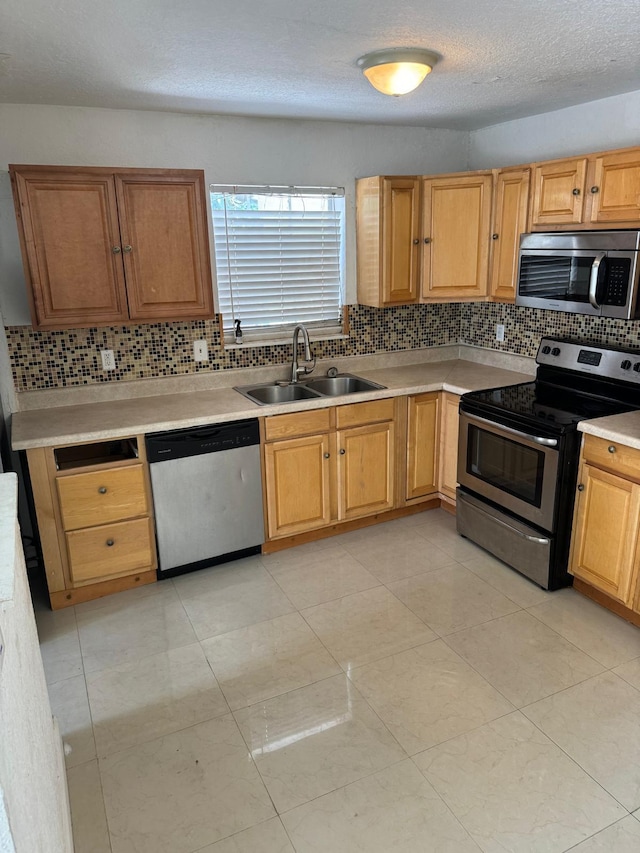 4420 NW 34th St, Lauderdale Lakes, FL 33319 - kitchen with appliances with stainless steel finishes, a sink, backsplash, light countertops, and light tile patterned floors