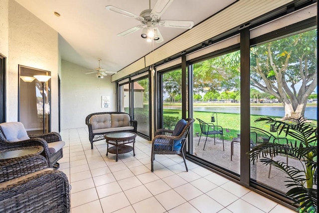 sunroom featuring a ceiling fan, a water view, lofted ceiling, and an outdoor living space
