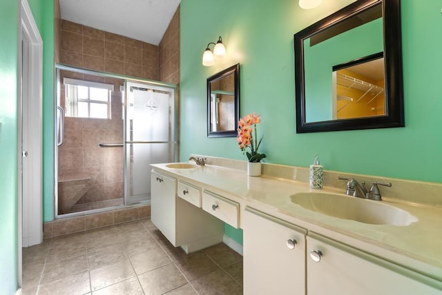full bathroom featuring a shower stall, tile patterned flooring, and double vanity