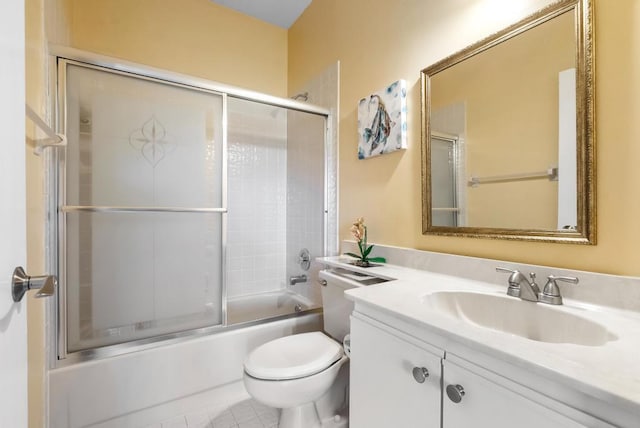 full bathroom with toilet, vanity, and bath / shower combo with glass door