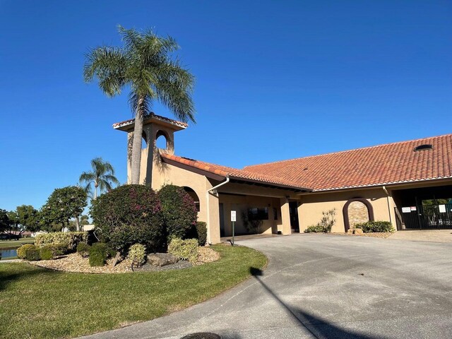 view of front of house with a tiled roof and stucco siding