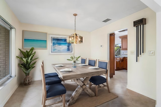 1467 NE 57th Ct, Fort Lauderdale, FL 33334 - dining space featuring light tile patterned floors, a chandelier, and baseboards