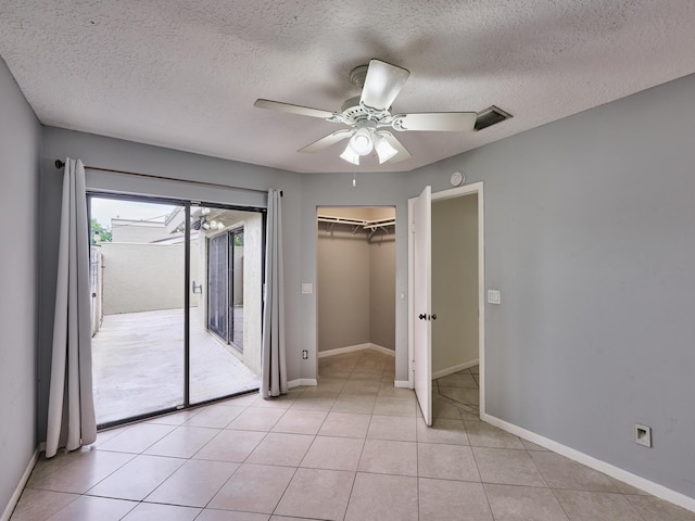 151 Meadows Dr, Boynton Beach, FL 33436 - unfurnished bedroom with access to outside, a textured ceiling, ceiling fan, baseboards, and light tile patterned floors